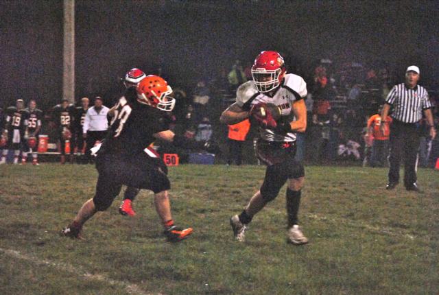 Calhoun moves the ball toward Greenfield-Northwestern's goal line in these two photos. (Photos by Allison Godar)