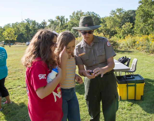 Leighann Jones of the U.S. Army Corps of Engineers teaches students about “Critters of the River” in a geocaching scavenger hunt during the 2018 Water Festival at Lewis and Clark Community College.