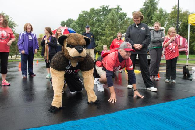 SIUE Chancellor Randy Pembrook and mascot Eddie the Cougar take their places at the starting line during the inaugural Cougars Unleashed Homecoming Run.