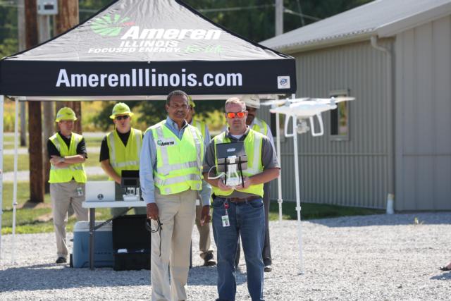 Ameren Illinois President Richard Mark watches drone pilot Kyle Maxwell, superintendent of Electric Operations, fly one of 36 drones the company is now using to observe damage after a storm. 