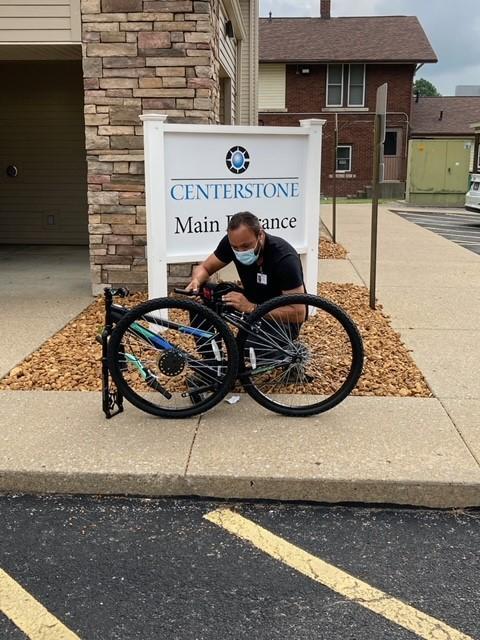 Ben Stoller, Centestone Case Manager, builds a bicycle purchased with a special grant from Shawnee Preparedness and Response Coalition to help those experiencing homelessness.