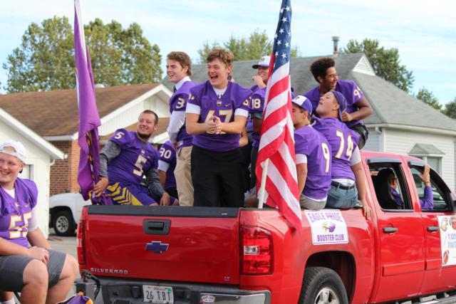 Members of the CM Varsity squad laugh at their teammate who ran to hop back on the trailer.