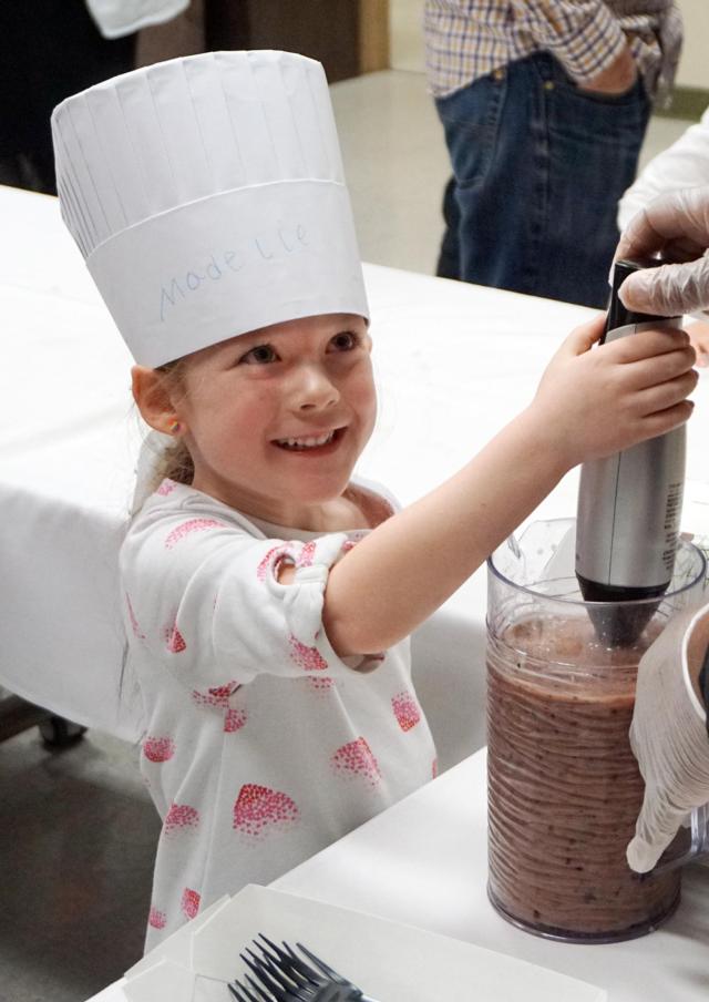 Madeline Pluester, 6, of Wood River helps stir a vegetable smoothie during the last “Kids in the Kitchen” event at Alton Memorial Hospital in February.