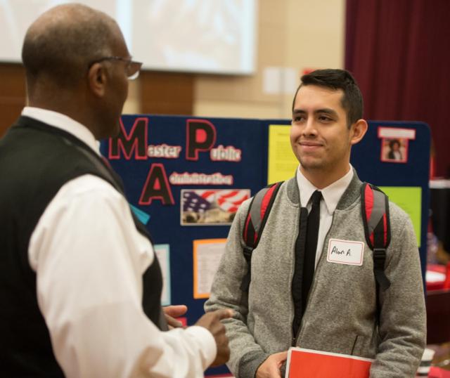  Alan Ayala, of Springfield, met with Morris Taylor, PhD, associate professor and chair of the public administration and policy analysis program, during SIUE’s Graduate School Open House. 