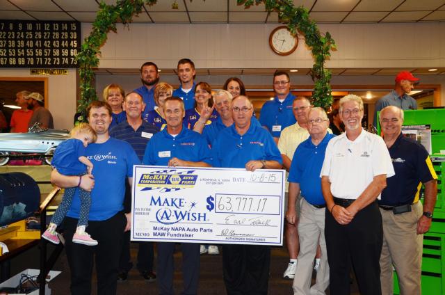 Front, L-R: Make-A-Wish recipient Grace Herschelmann of Hillsboro and her dad, Kyle; President Earl Flack; Vice-President Ed Hammann; Bill Hefley, Outside Sales; Outside Sales Manager, Norman May; and Ed Keck, Outside Sales. Row two: Terry Arnold, PBE Specialist; Jim Portugal, Outside Sales; Customer George Kruse, of Kruse Enterprise in Girard and Virden, who raised $2,475.60 to add to the MAW funds. Row three: Sue Miller, Promotions Coordinator / Executive Assistant; Casey Logsdon and Toni White, Accounts Payable; Peggy Snell, Office Manager / Accounts Receivable; and Trevor Klump, Outside Sales. In back are Bill Stoneburner, Heavy Duty Specialist; and J. R. Stanton, PBE Specialist. Not present for the photo were Regional Manager Ryan Ocepek and Jim McKay.