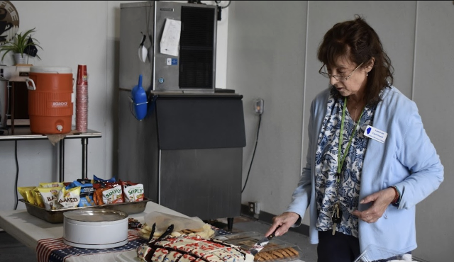 Looking Glass Prairie Chapter member Carol arranges the desserts.