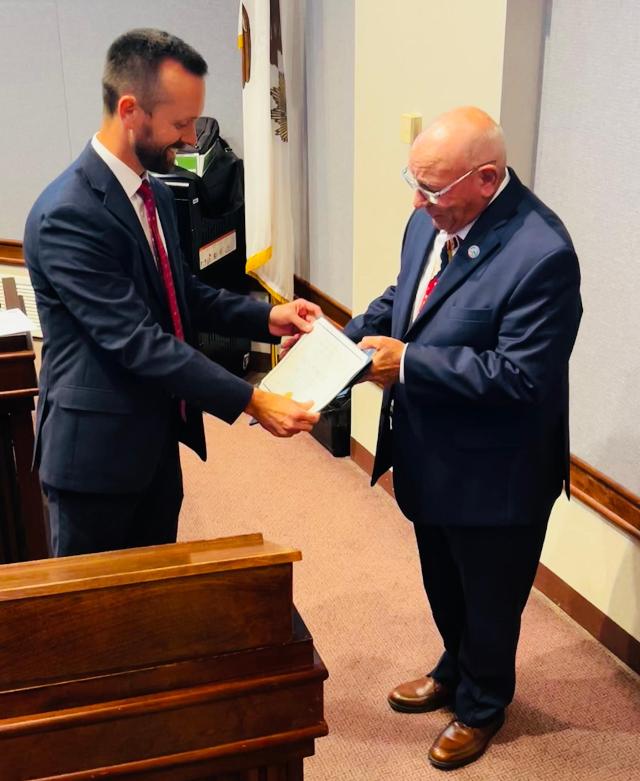  Chairman Chris Slusser presents County Board member Nick Petrillo of Granite City with a certificate recognizing him as the 2025 Champion of Mental Health. Since 2012, Petrillo has served as liaison between the Madison County Mental Health Board and County Board strengthening communication and cooperation.