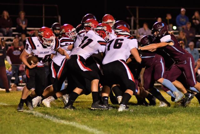 A big bunch of Warriors block in the game this past Friday night. (Photo by Bonnie Snyders)