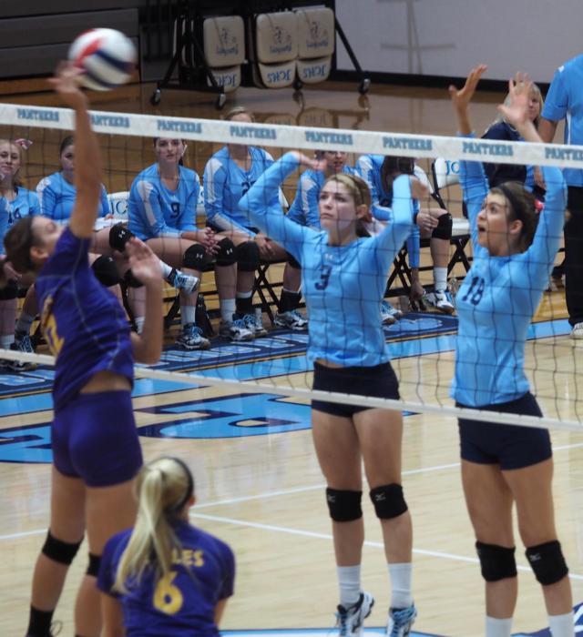 Alexis Liles (3) and Faith Franke (18) attempt to block a kill. (Photo by John Hough)