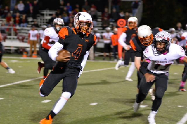 The Tigers' Kendall Abdur-Rahman rolls around end on Friday night. (Photo by Dan Brannan)