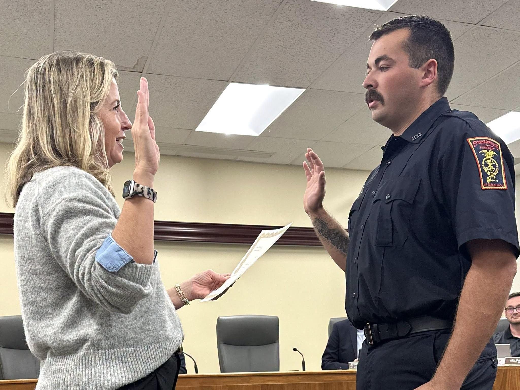 Probationary Firefighter Jacob Milton (right) takes the oath of office administered by City Clerk Michelle Boyer (left).