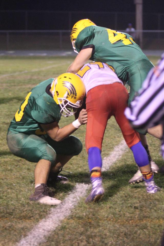 Southwestern senior Joe Carrigan and senior Race Davis bringing down the Roxana ball carrier Jared Foiles Friday night. (Photo courtesy of Leslie Manula) 