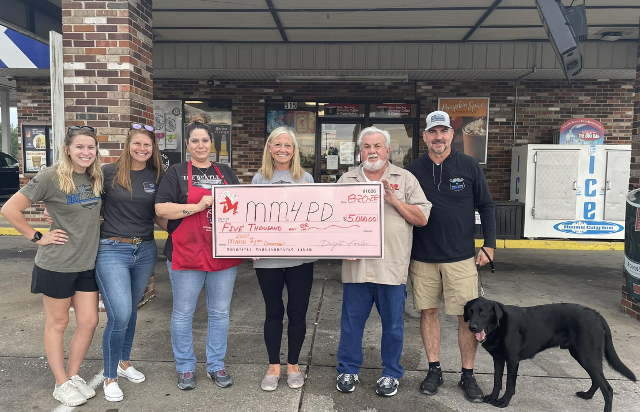 Fowler's present check to Mustache March for Annual Police Department Fundraiser.