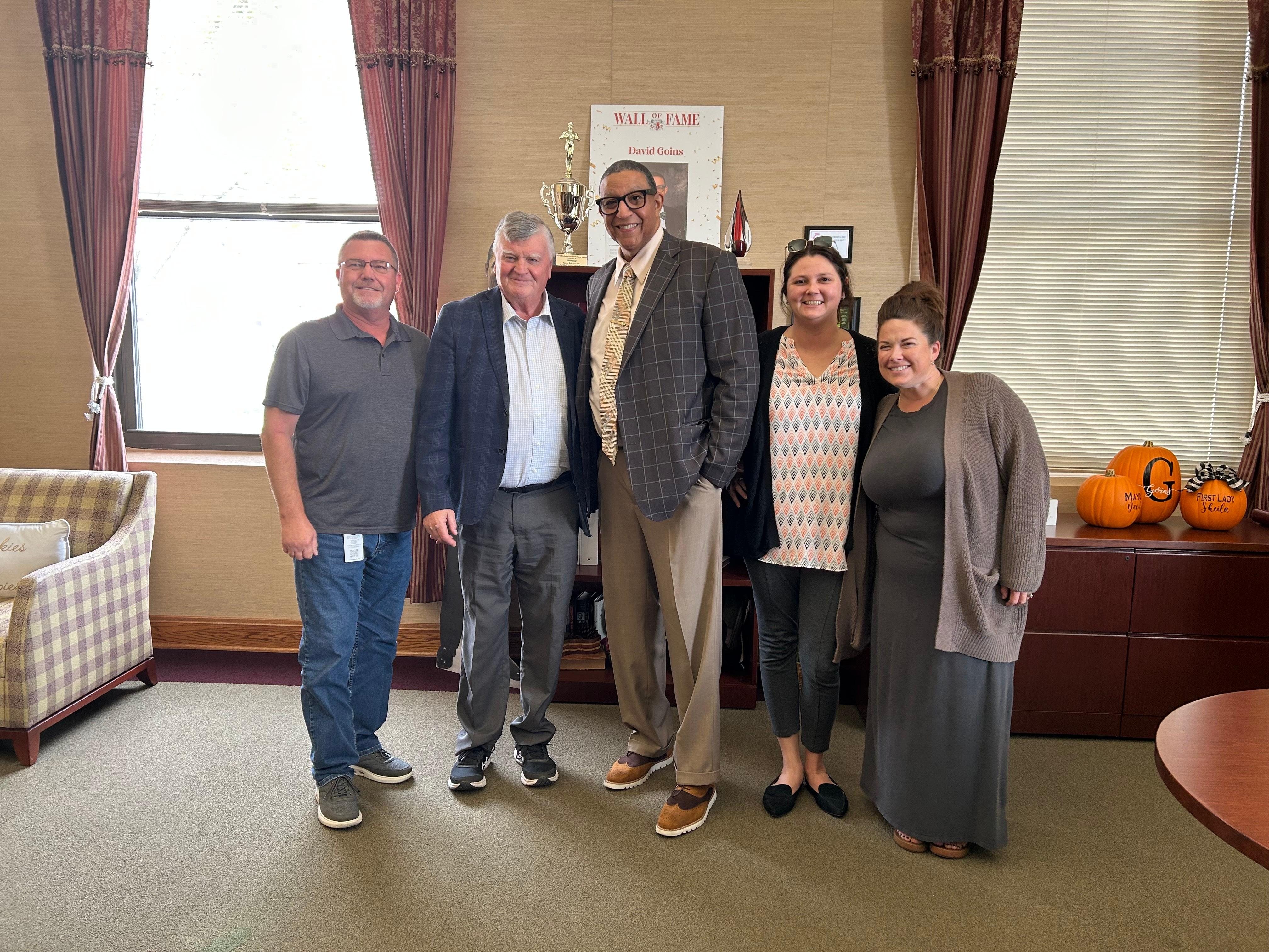 Department heads at Alton City Hall smile with Mayors Claude Elliott and David Goins.