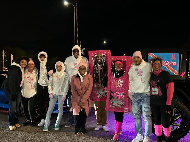 David Goins, Sheila Goins and Tina Mills pose with family and friends in front of their 