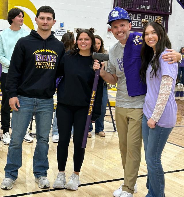 Principal Justin Newell smiles with the high school's student body presidents.