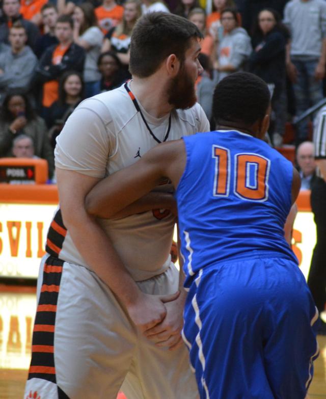 Edwardsville's Zack Doornick underneath the basket against East St. Louis battling for position. (Photo by Dan Brannan)