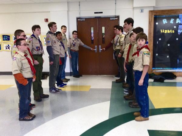 Boy Scouts line the enterance to the gymnasium of North Elementary School to make way for U.S. Marine Cpl. Jordan A. Cook upon arriving at his welcome home ceremony, Jan. 4, organized by Mission: American Gratitude - A Hero's Welcoming