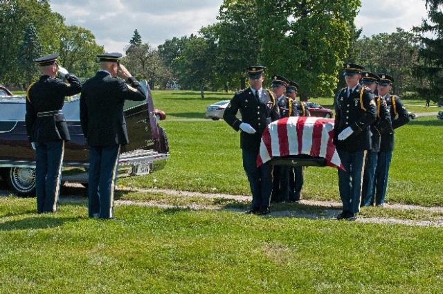A six Soldier casket bearer detail as part of a modified soldier detail provide support during the burial ceremony for Command Sgt. Maj. Allen Kirkpatrick in 2016. (U.S. Army Photo, Illinois National Guard Public Affairs)