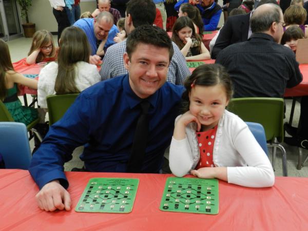 Chloe Bland and her daddy, Kevin, have ball playing Fun BINGO at the Friday night dance in 2014.