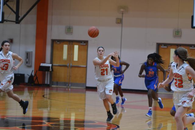 Rachel Pranger tosses a pass downcourt in Tuesday's game. Pranger led the Tigers in scoring with 21 points. (Photo by Dan Brannan)