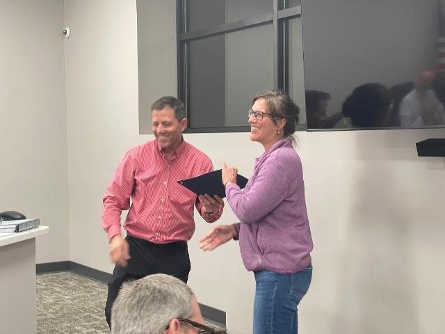 Commissioner of Accounts and Finance Tony Steckel (left) presents a Service Award to Deputy City Clerk Michelle Niemeyer (right).