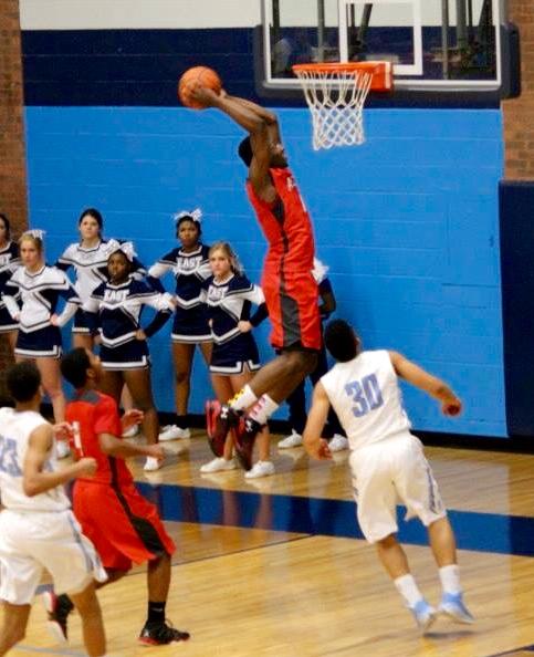 Carlos Anderson slams one home against Belleville East. (Photos courtesy of Alton High basketball Facebook page)