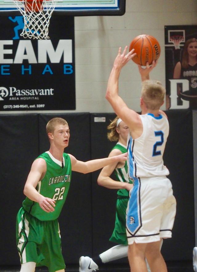 Shawn Bell shoots a three-point shot in front of Jones and Flowers in the second half.