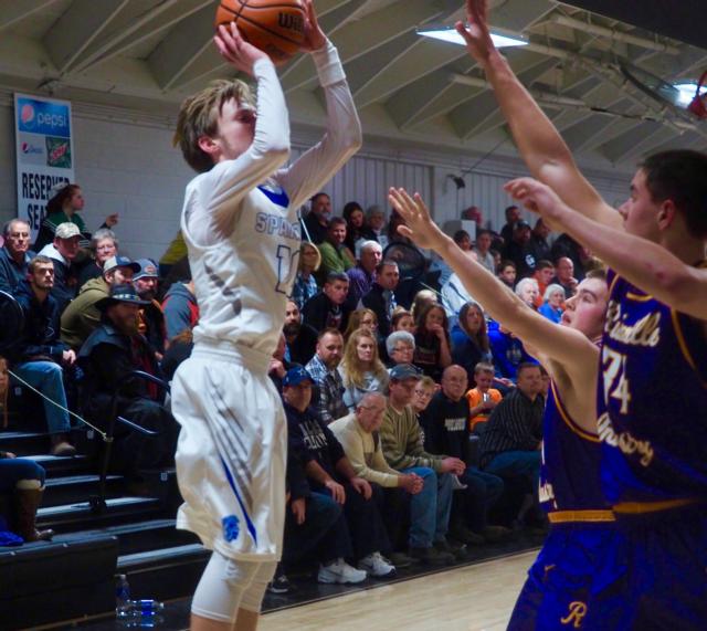 North Greene's Brett Whicker attempts a shot as two Rushville-Industry defenders try to block his shot in the Winchester Invitational Tournament.