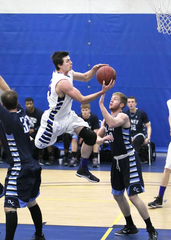 Trailblazers Burak Eslik (24) goes up for two against Olney&rsquo;s Tyler Brough. Photos by S. Paige Allen, L&C photographer