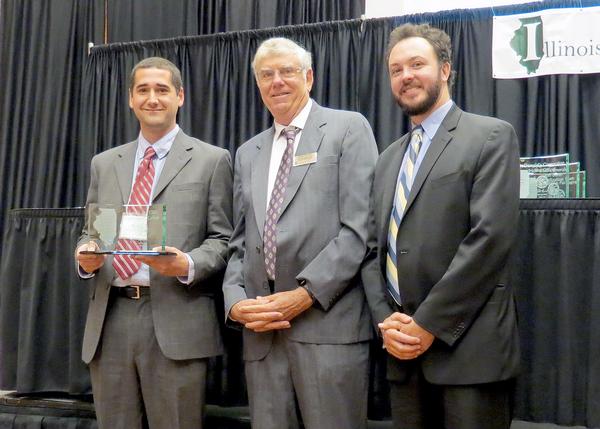 L&C Direc tor of Sustainability N ate Keener, right, rec eives the 2013 G overnor&rsquo;s S ustainability Award on behalf of Lewis and C lark from David Thomas, of IS TC , and E ric Heineman, far left, from G overnor Pat Q uinn&rsquo;s office.