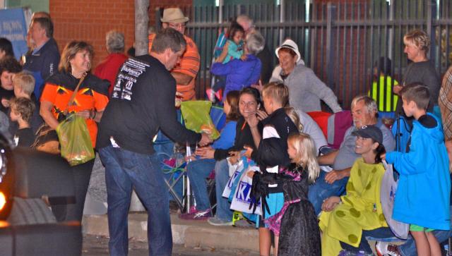 Edwardsville Mayor Hal Patton passes out candy in Downtown Edwardsville during the Halloween Parade on Monday night. (Photo by Dan Brannan)