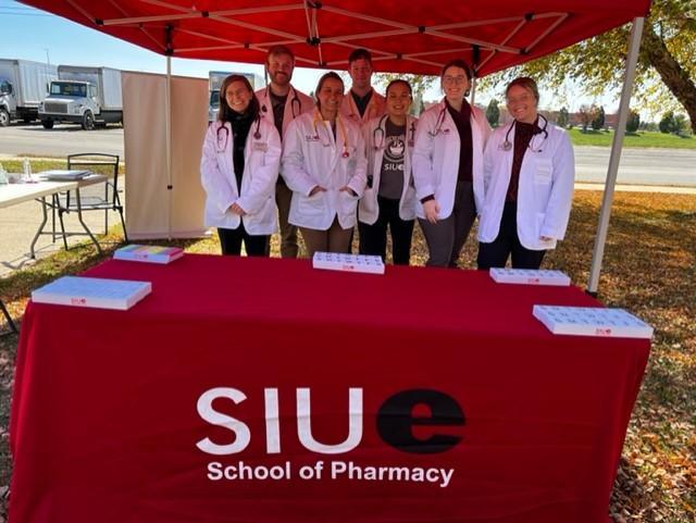 SIUE School of Pharmacy students assist with food distribution and provide free health checks at a local food pantry.