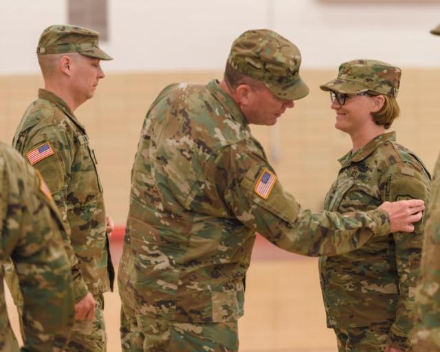 The Adjutant General of Illinois, Maj. Gen. Richard J. Hayes, Jr., places a patch on Chief Warrant Officer 2 Elizabeth Tinker's left arm during the activation ceremony for the 176th Cyber Protection Team Nov. 5, 2017 in Bloomington, Illinois. (U.S. Army photo by Staff Sgt. Robert R. Adams)
