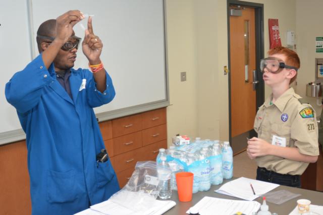 Dr. Myron Jones, SIUE Assistant Professor of Chemistry, shows scout Makinley Korte how to build a Cartesian Diver.