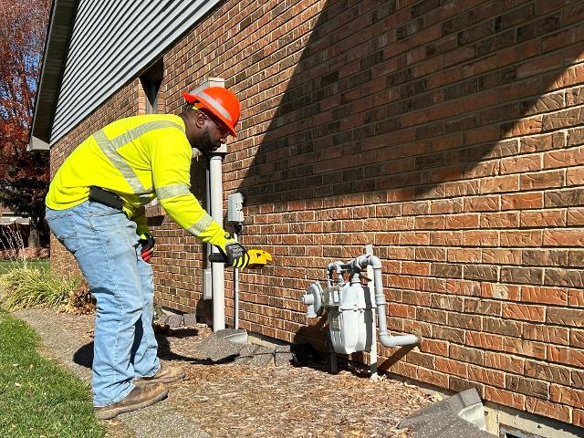 Journeyman Larry Beard uses a combustible gas indicator to check for a natural gas leak.