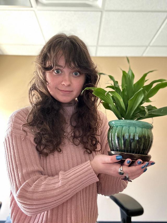 Me with my office plant, which I have somehow managed not to kill. This was already one of the most embarrassing selfies I've ever taken, but then my boss walked by my office while I was taking it, so it's been a rough morning.