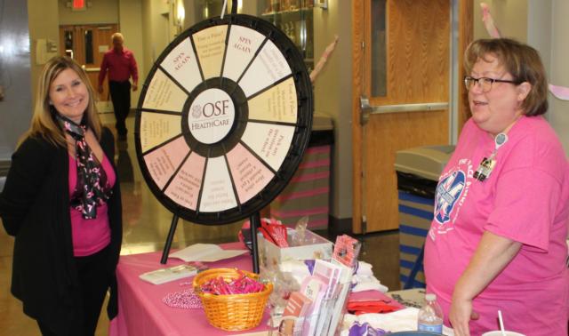 OSF Saint Anthony&rsquo;s Mission Partners Heather Jones (left) and Tammy Stillwell (right) provide breast cancer information and education at the 3rd annual Volley for the Cure at Marquette Catholic High School.