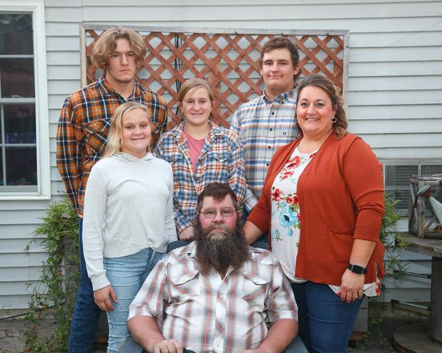 Walt and his family outside of their home.