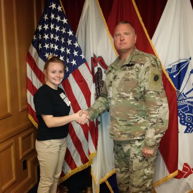 Pvt. Cheyenne Hogue, of Greenville, Illinois, shakes hands with Sgt. 1st Class Thomas Reif, an Illinois National Guard recruiter, at the St. Louis Military Entrance Processing Station Nov. 7. Hogue enlisted as a 74D, Chemical, Biological, Radiological and Nuclear (CBRN) Specialist and will be assigned to Company M, Recruit Sustainment Program, based in Shiloh, Illinois.