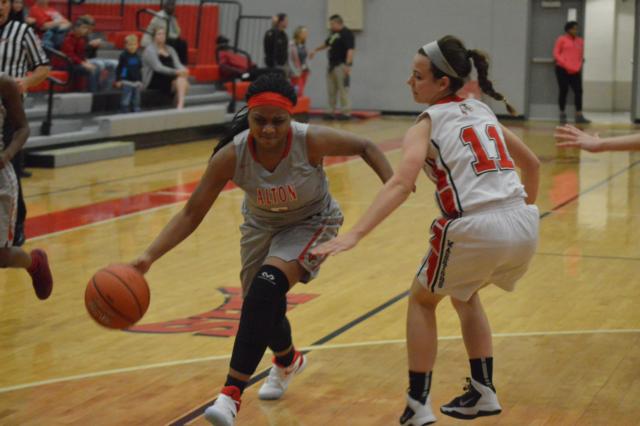 Emily McBride (No. 11) guards her Alton opponent.