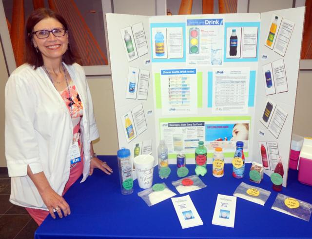 Eileen Cheatham, parish nurse at Alton Memorial Hospital, with the “Rethink Your Drink” display she takes to area health fairs.