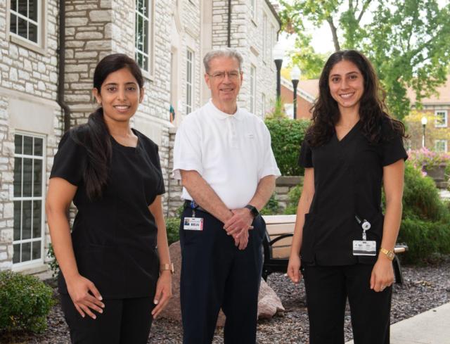 SIU SDM endodontics post graduate program director Marvin Leigh Speer, DDS, MS, FACD stands in center with program residents Priya Sapra Kullar (left) and Tara Habibi (right).