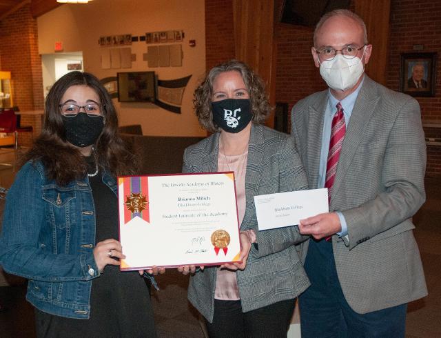 Blackburn College Lincoln Academy Student Laureate Brianna Milich (left) is pictured receiving her award from Dr. Michelle Stacy, Professor of Education; and Dr. Mark Biermann, President of Blackburn. (credit Blackburn College)