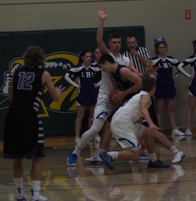 Center, Jake Hall (25) and Chris Hartrich (5) double-team Luke Krumsieg.