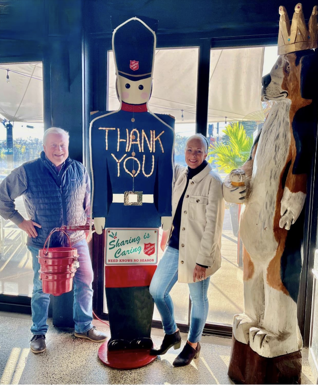  John and Cathy Keller stand next to The Salvation Army soldier at the Regal Beagle in Godfrey, IL. When a donation is placed in the kettle, the soldier signifies his appreciation by lighting up with a big &ldquo;THANK YOU.&rdquo; (Photo by Marlene Lewis)