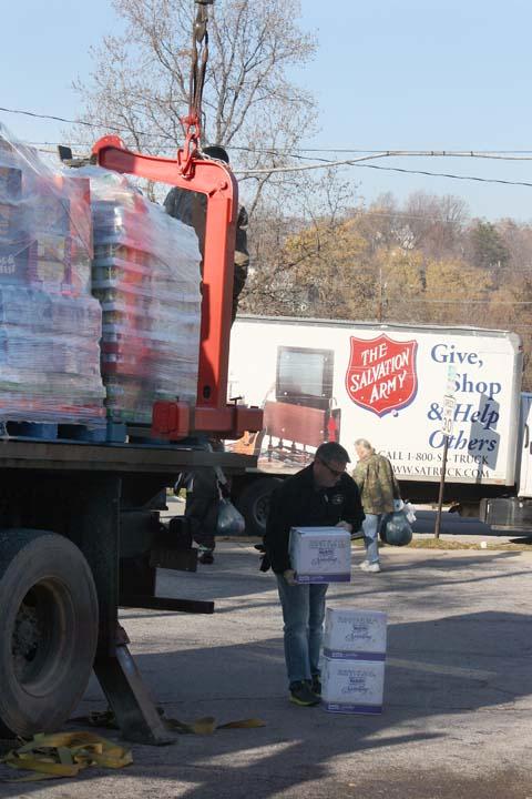  Simmons Attorney Andy Williams helps unload pallets filled with items from the 6th Annual Simmons Employee Foundation Food Drive at the Alton Salvation Army. The drive raised 36,430 pounds of food that were delivered to five area food pantries on Friday.
