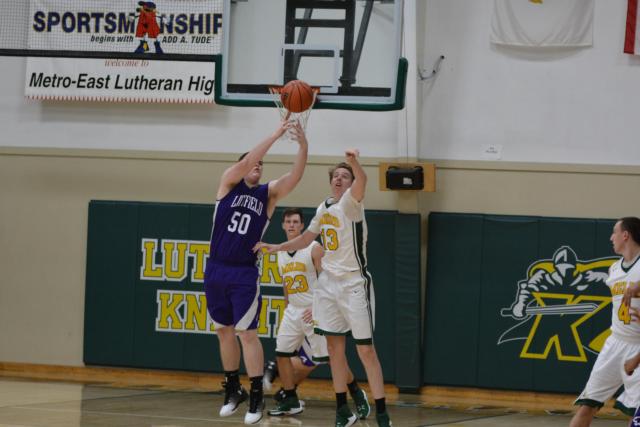 Senior A.J. Risavy goes for the ball on defense for the Knights. (Photo by Dan Brannan)