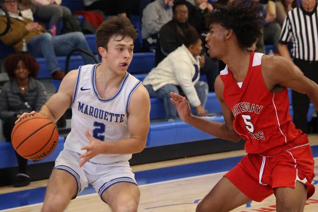 Marquette senior guard Braden Kline makes a move past Gateway Legacy&rsquo;s senior guard Rafael Oliveria Wednesday afternoon at the 2023 Hoopsgiving Classic hosted by Roxana High School. (Photo by Brad Piros)