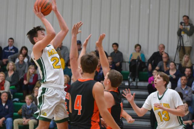 Metro East Lutheran's No. 23 Braden Woolsey pulls up for a shot. He had 24 points in MELHS' win over Marissa on Friday in the MELHS Thanksgiving Tourney. (Photo by Dan Brannan)